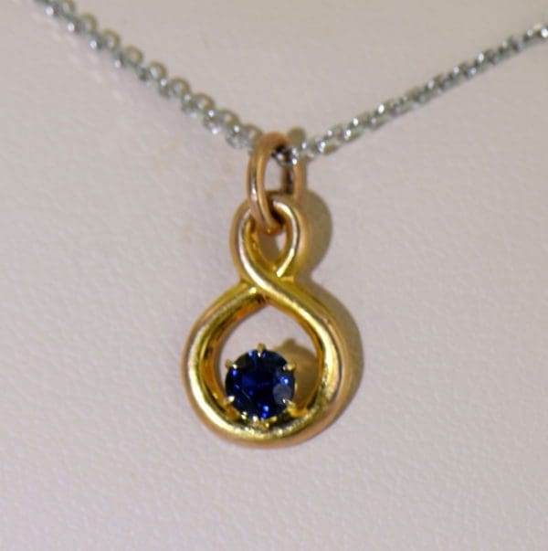 Edwardian Infinity Pendant with Round Blue Sapphire Pin Conversion 2 natural light.JPG