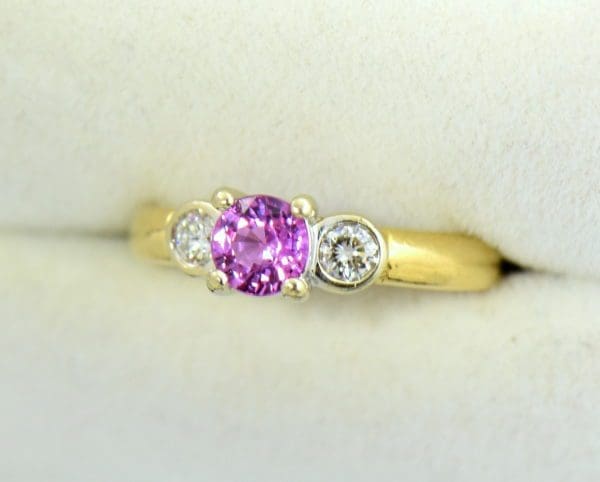 Round pink sapphire bezel diamond three stone ring.JPG