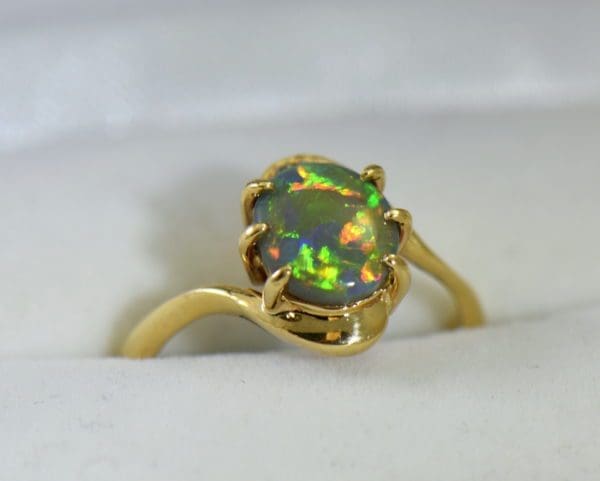 Australian Semi Black Opal set in Yellow Gold Bypass Ring Mounting with Diamond Accents.JPG