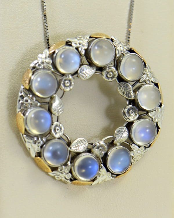 large 1930s floral wreath pendant with blue moonstones in sterling and 14k.JPG
