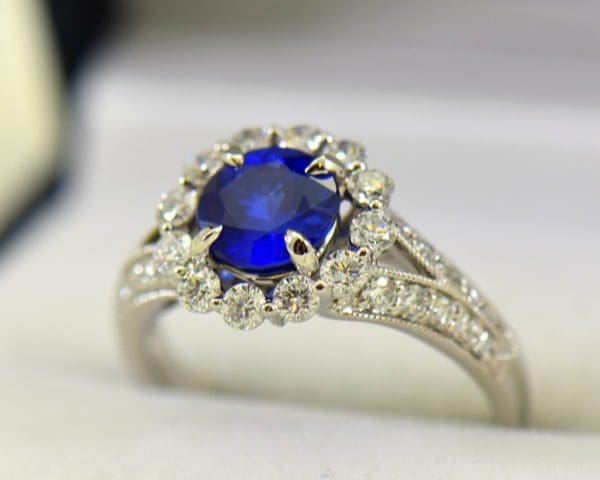 Round blue sapphire diamond halo engagement ring in white gold