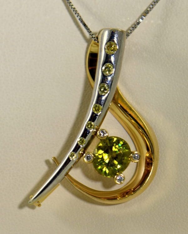 custom designed pin or pendant with sphene and yellow diamonds treble clef 2.JPG