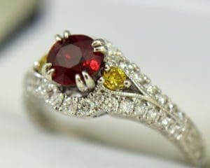 Vintage style ruby ring with yellow diamond support.