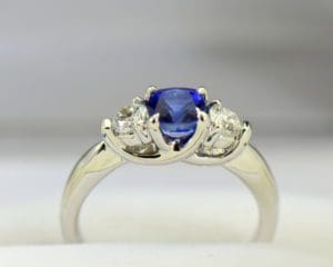 Blue Sapphire Supported by Diamonds - Three Stone Engagement Ring