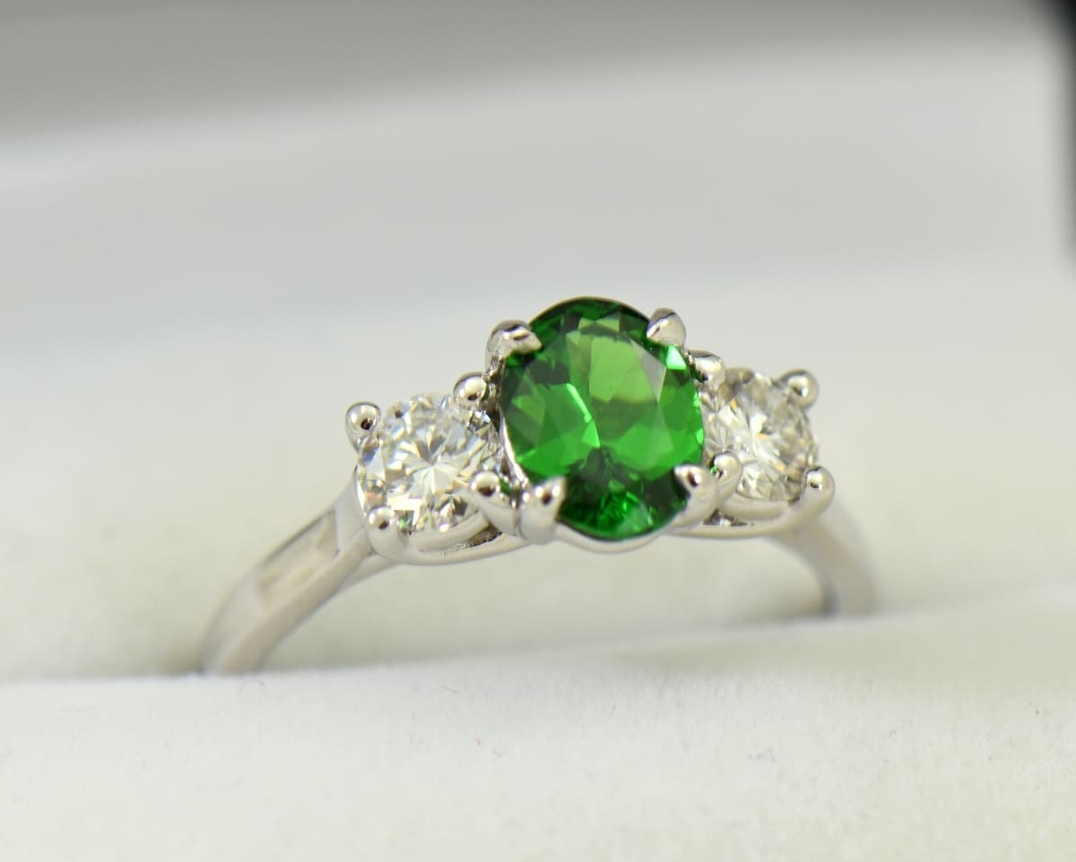 white gold three stone ring with diamonds and oval tsavorite green garnet.JPG