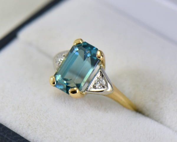emerald cut blue zircon 3 stone ring in deco mounting.JPG