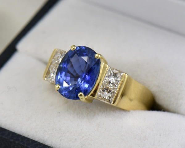 estate cocktail ring with 6ct cushion blue sapphire and princess diamonds in 18k yellow gold.JPG