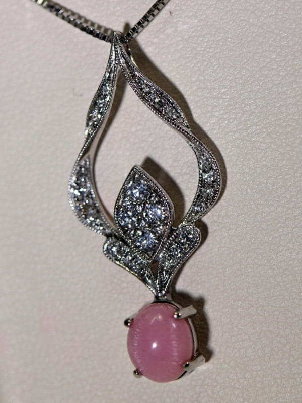 pink conch pearl custom pendant with diamonds.JPG