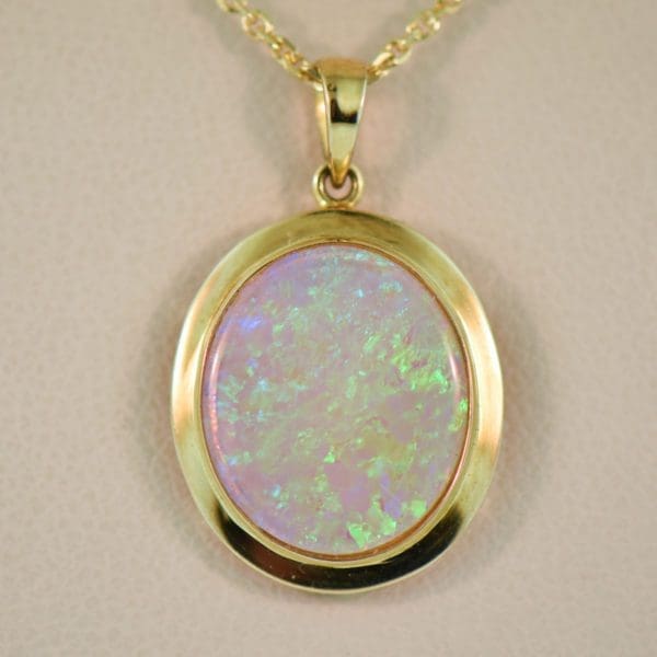 large oval australian crystal opal pendant in yellow gold bezel 4
