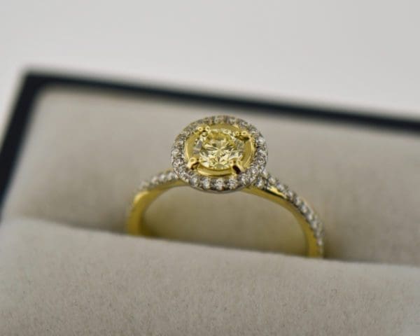 round yellow diamond engagement ring in yellow gold halo mounting