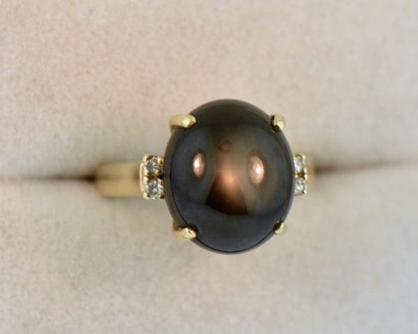 large black star sapphire ladies ring yellow gold