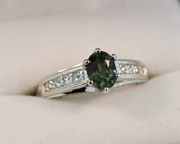 natural forest green sapphire and channel set diamond engagement ring