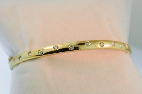 hinged gold bangle bracelet with gypsy set diamonds