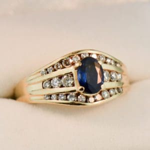 yellow gold channel set diamond and navy blue sapphire estate ring