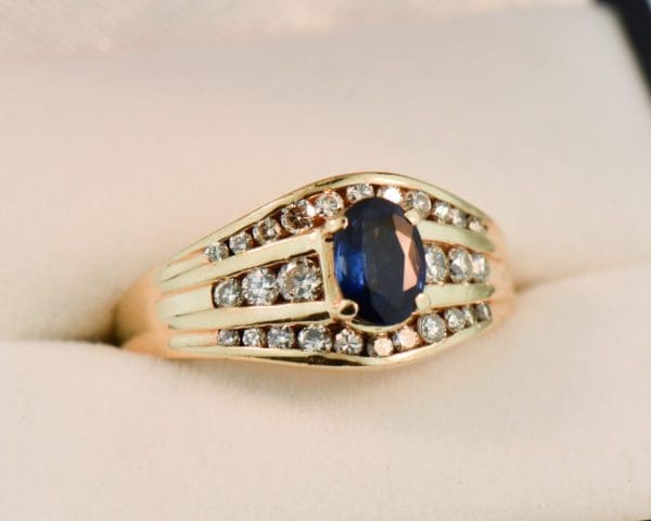 yellow gold channel set diamond and navy blue sapphire estate ring