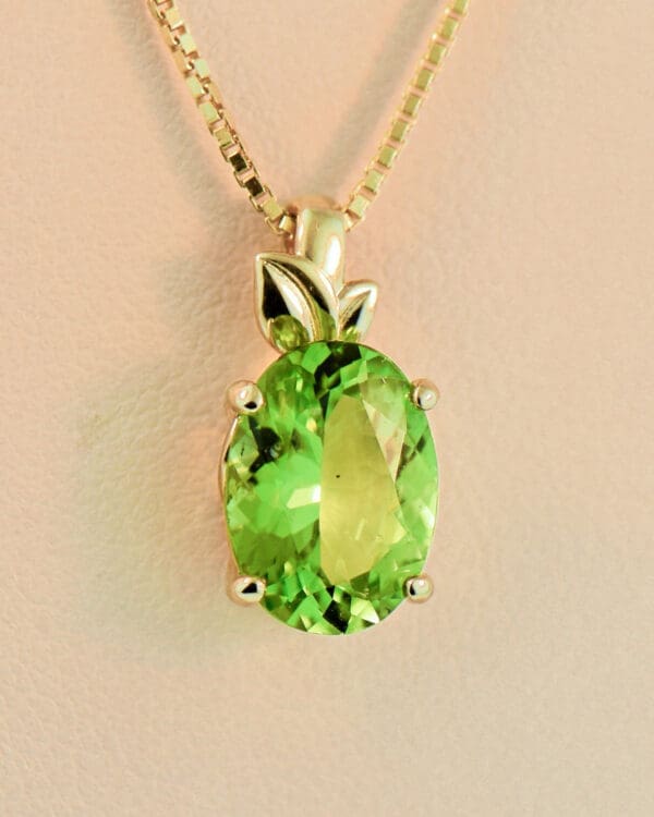 burmese peridot solitaire pendant with leaf trim