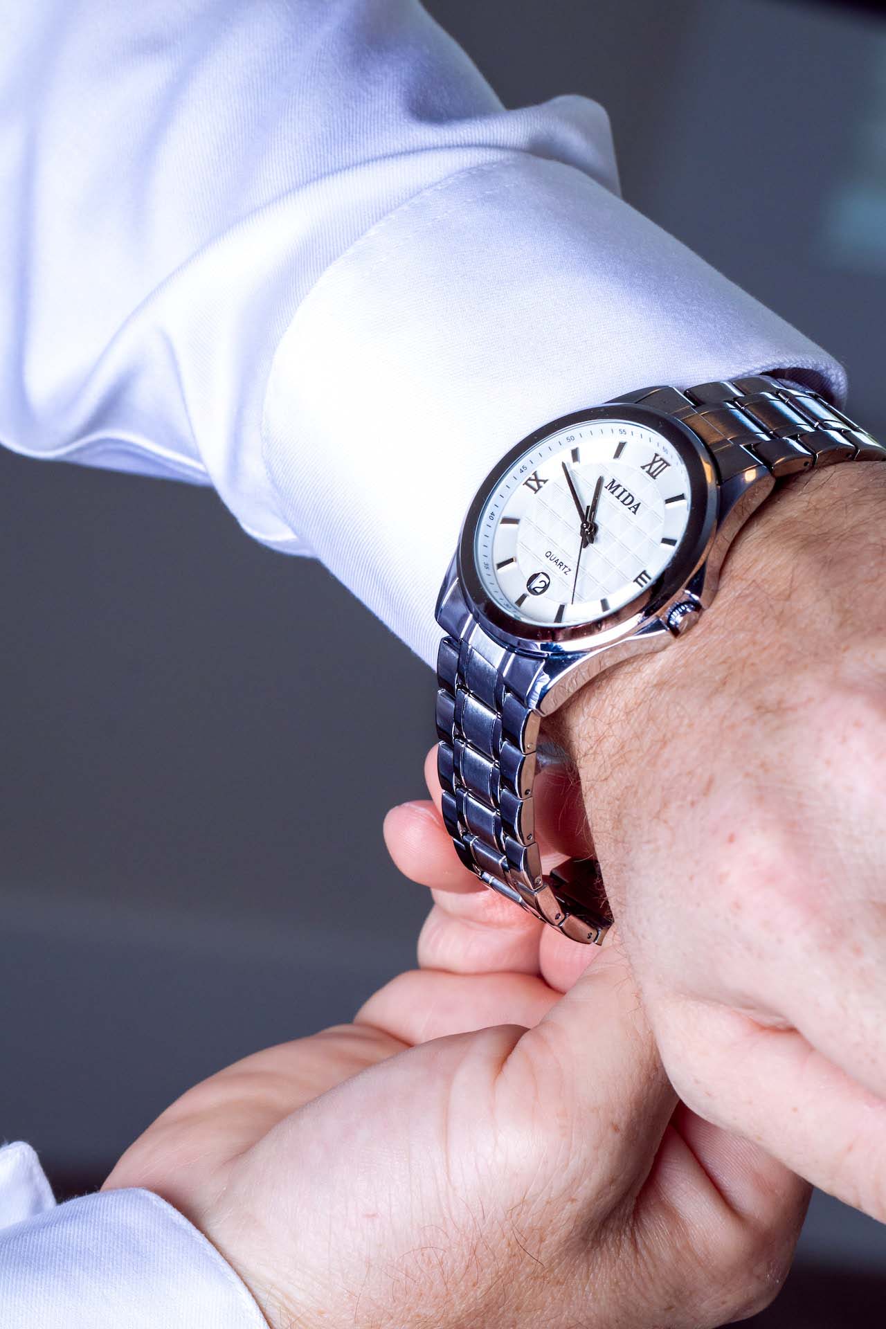 watch repair man putting on watch