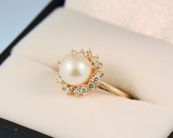 akoya white pearl and diamond halo ring in yellow gold