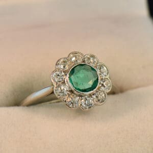 art deco platinum emerald diamond flower halo ring