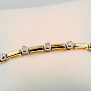 bezel set diamond and gold link twotone tennis bracelet