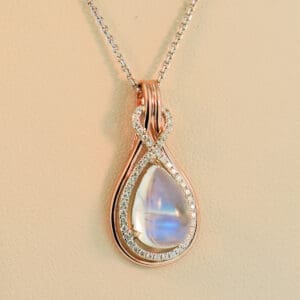 custom rose gold pear pendant with blue moonstone and diamonds