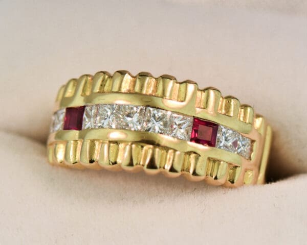 estate yellow gold ring with row of channel set diamonds and rubies