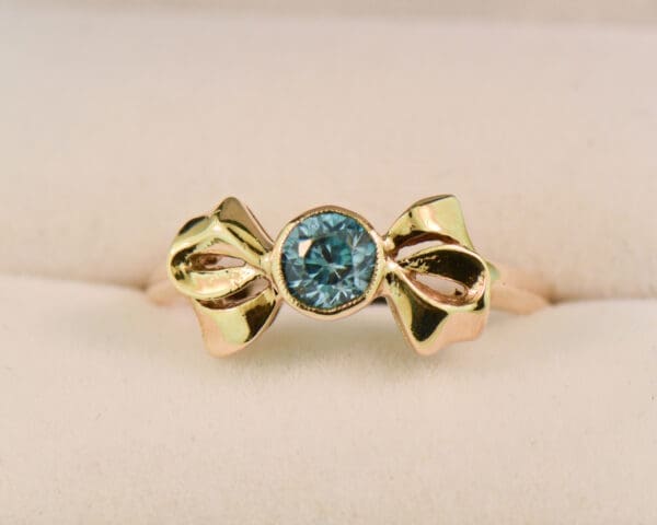 retro gold bow ring with bezel set blue zircon