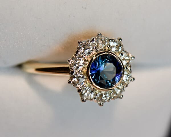 antique yellow gold halo engagement ring set with teal sapphire and diamonds 2