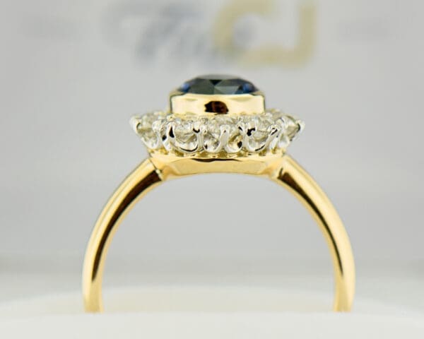 antique yellow gold halo engagement ring set with teal sapphire and diamonds 3