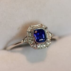 deco style dainty emerald cut blue sapphire engagement ring