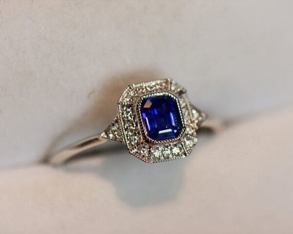 deco style dainty emerald cut blue sapphire engagement ring