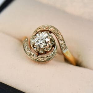 french antique diamond swirl engagement ring with old european cut center