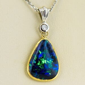 estate freeform black opal and diamond pendant in twotone gold