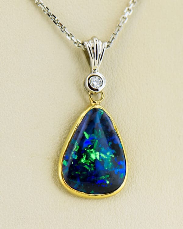 estate freeform black opal and diamond pendant in twotone gold