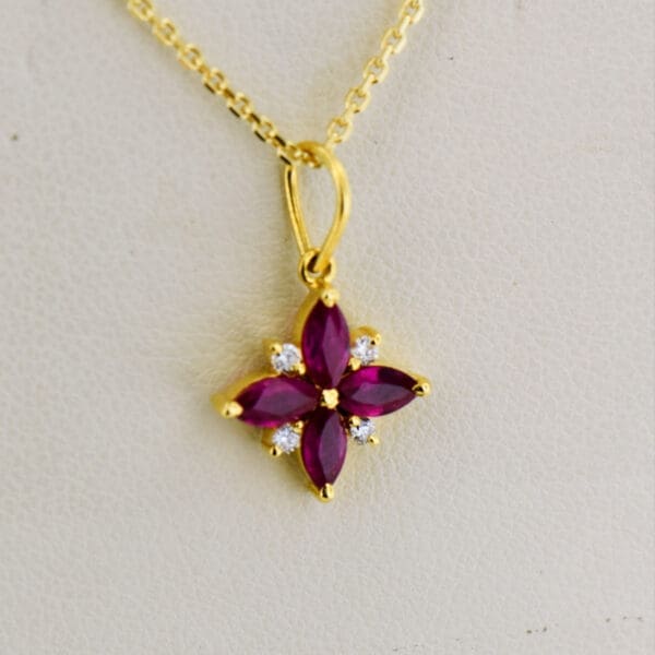 ruby clover pendant with diamond accents in 18k gold