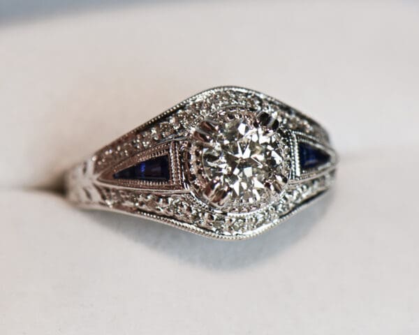 vintage style ring with old european cut diamond center and sapphire accents 4