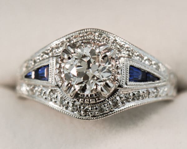 vintage style ring with old european cut diamond center and sapphire accents 5