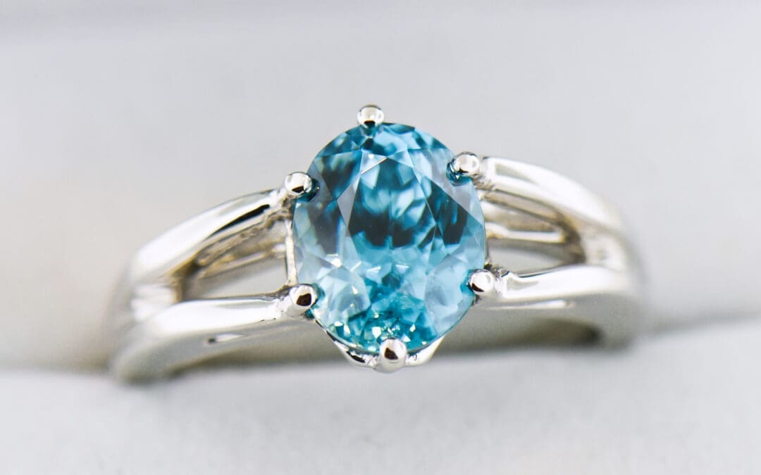custom blue zircon ring with white gold split shank