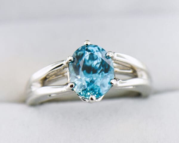 custom blue zircon ring with white gold split shank
