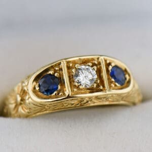 carved gold sapphire and diamond three stone wedding band