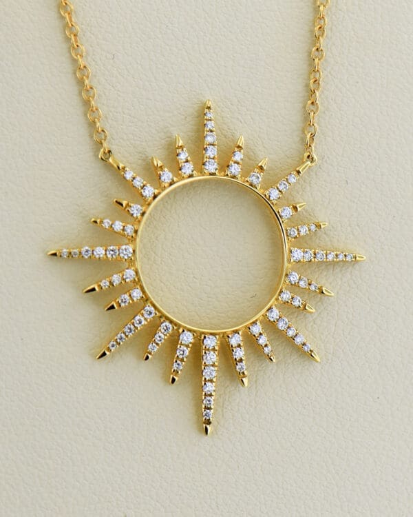 custom 18k gold and diamond sunburst pendant with diamond station chain