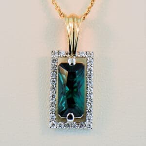 dyer cut radiant teal tourmaline and diamond halo pendant