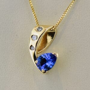 freeform gold pendant with pear tanzanite and diamonds