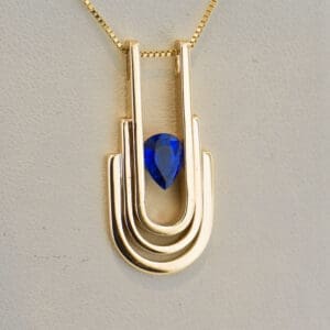modern art deco style heavy gold and blue sapphire pendant