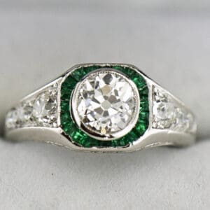 rare platinum art deco target ring with old euro cut diamond and calibre emerald accents
