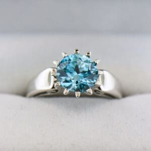 unusual solitaire blue zircon ring with crown prongs