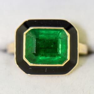 vintage 1980s bezel set ring with deep green emerald and black enamel