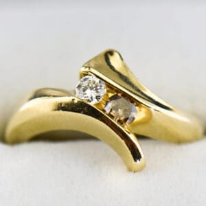 yellow gold bypass ring with champagne and white diamonds