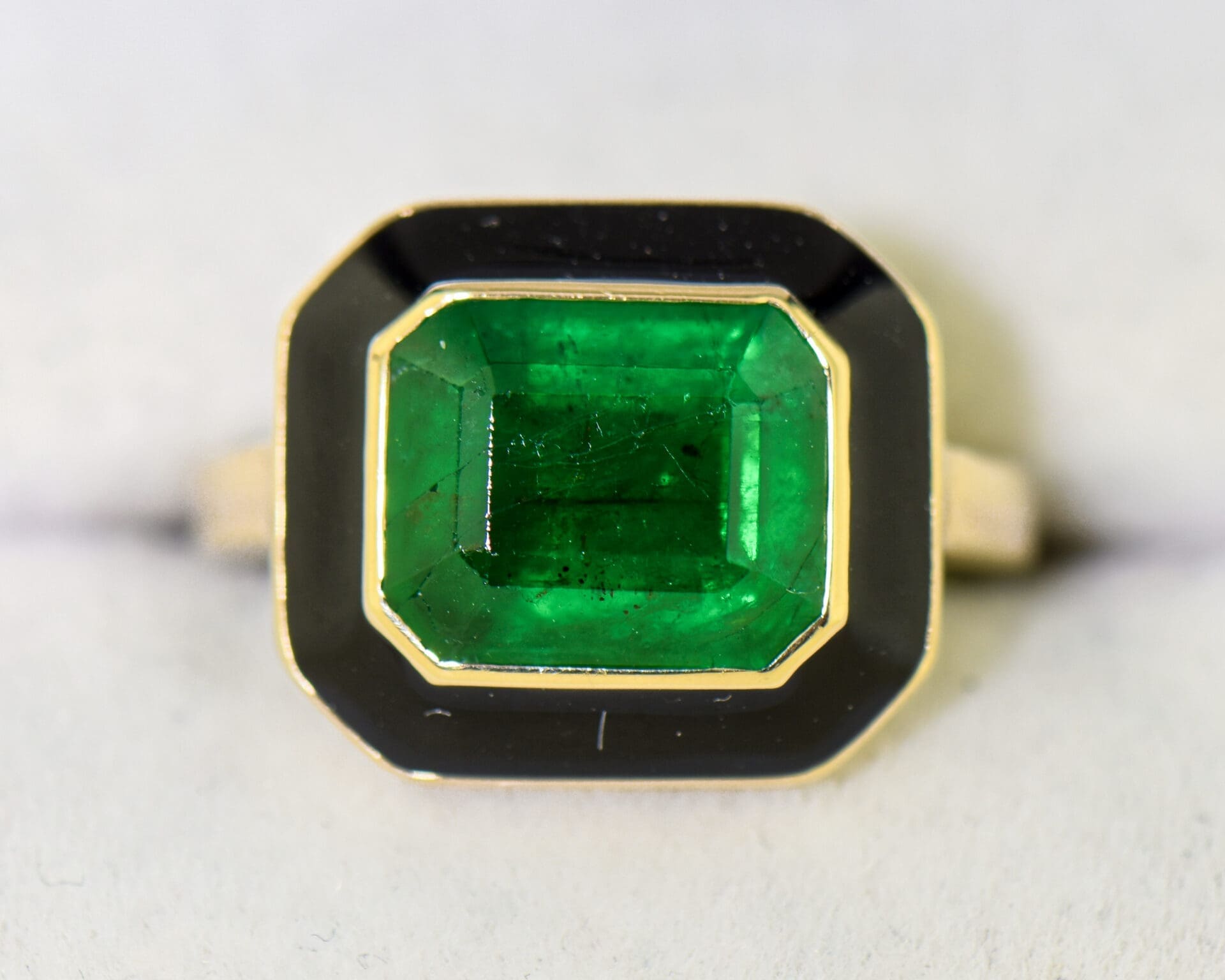 vintage 1980s bezel set ring with deep green emerald and black enamel