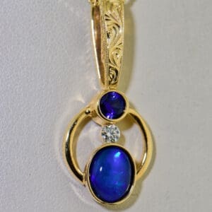 amazing custom gold pendant with blue black opal and blue sapphire